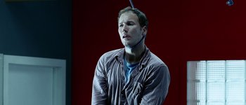 Movie still from “Hard Candy” (2005), directed by David Slade – A man with a blue object in his head; Close Up shot, High angle