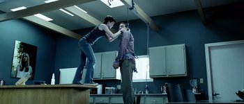 Movie still from “Hard Candy” (2005), directed by David Slade – A woman is helping a man tie up his shirt; Wide shot, Low angle