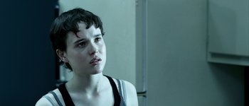 Movie still from “Hard Candy” (2005), directed by David Slade – A young woman with short black hair looking at the camera; Close Up shot, Over the shoulder angle