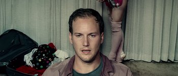 Movie still from “Hard Candy” (2005), directed by David Slade – A man with a beard is posing for a picture; Close Up shot, Low angle