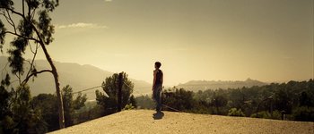 Movie still from “Hard Candy” (2005), directed by David Slade – A person standing on top of a dirt hill; Extreme Wide shot, High angle