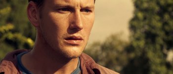 Movie still from “Hard Candy” (2005), directed by David Slade – A man's face with trees in the background; Close Up shot, Low angle