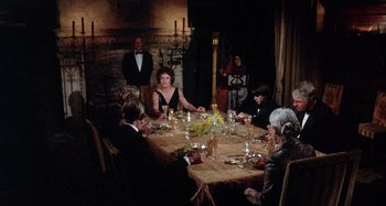 Movie still from “Harold and Maude” (1971), directed by Hal Ashby – A group of people sitting around a table; Wide shot, High angle
