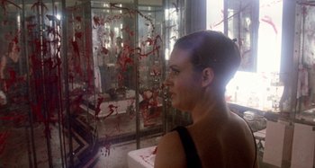 Movie still from “Harold and Maude” (1971), directed by Hal Ashby – A woman standing in front of a mirror with blood on it; Close Up shot, Over the shoulder angle