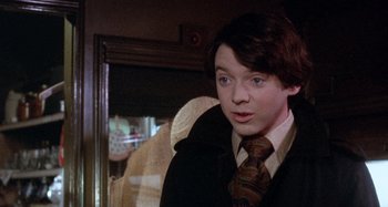 Movie still from “Harold and Maude” (1971), directed by Hal Ashby – A young man wearing a suit and a tie; Close Up shot, Over the shoulder angle