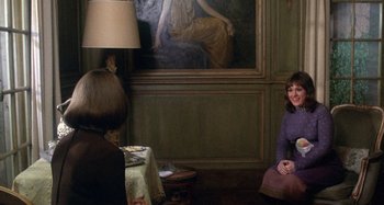 Movie still from “Harold and Maude” (1971), directed by Hal Ashby – Two women sitting in front of a painting of a woman; Wide shot, Over the shoulder angle