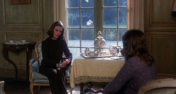 Movie still from “Harold and Maude” (1971), directed by Hal Ashby – Two women sitting in front of a table with a tea pot on top of it; Medium shot, Over the shoulder angle