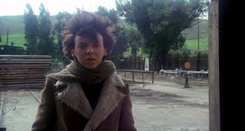 Movie still from “Harold and Maude” (1971), directed by Hal Ashby – A person with a fur coat and a scarf on; Close Up shot, Low angle