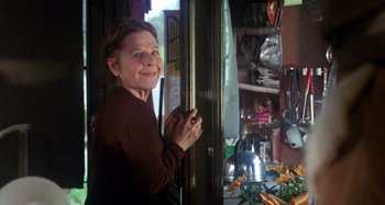 Movie still from “Harold and Maude” (1971), directed by Hal Ashby – An older woman standing in front of a window; Medium shot, Low angle