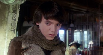 Movie still from “Harold and Maude” (1971), directed by Hal Ashby – A young man wearing a fur coat and a scarf; Close Up shot, Low angle