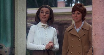 Movie still from “Harold and Maude” (1971), directed by Hal Ashby – Two women standing next to each other in front of a building; Medium shot, Low angle