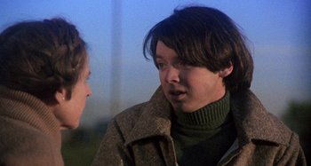 Movie still from “Harold and Maude” (1971), directed by Hal Ashby – Two people talking to each other outside in the evening; Close Up shot, Over the shoulder angle