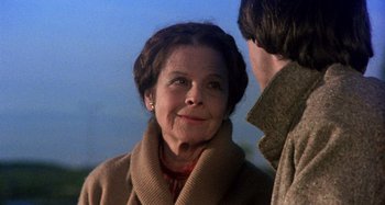 Movie still from “Harold and Maude” (1971), directed by Hal Ashby – An older woman wearing a brown coat looking at the camera; Close Up shot, Over the shoulder angle