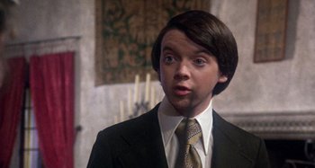 Movie still from “Harold and Maude” (1971), directed by Hal Ashby – A man in a suit and tie looking surprised; Close Up shot, Low angle