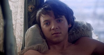 Movie still from “Harold and Maude” (1971), directed by Hal Ashby – A young man is laying on his back with a pillow; Close Up shot, Low angle