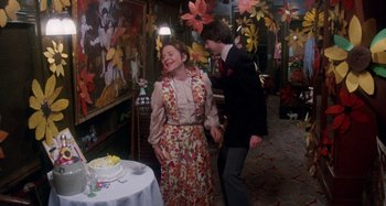Movie still from “Harold and Maude” (1971), directed by Hal Ashby – A man and a woman standing in front of a cake; Medium shot, High angle