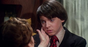 Movie still from “Harold and Maude” (1971), directed by Hal Ashby – A young man looking at his reflection in a mirror; Close Up shot, Over the shoulder angle