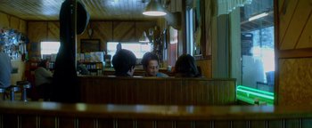 Movie still from “Haywire” (2011), directed by Steven Soderbergh – A group of people sitting at a table in a restaurant; Medium shot, Over the shoulder angle