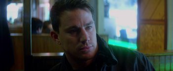 Movie still from “Haywire” (2011), directed by Steven Soderbergh – A person wearing a black jacket; Close Up shot, Over the shoulder angle