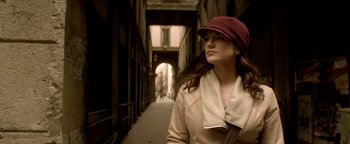 Movie still from “Haywire” (2011), directed by Steven Soderbergh – A woman wearing a hat walking down a street; Close Up shot, Low angle