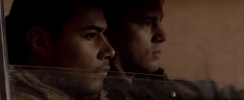 Movie still from “Haywire” (2011), directed by Steven Soderbergh – Two men are looking at each other in the dark; Close Up shot, Over the shoulder angle