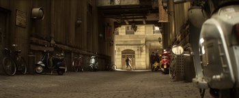 Movie still from “Haywire” (2011), directed by Steven Soderbergh – A couple of scooters are parked in a building; Extreme Wide shot, High angle