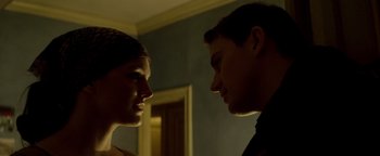 Movie still from “Haywire” (2011), directed by Steven Soderbergh – A man and a woman face to face in a dark room; Close Up shot, Low angle