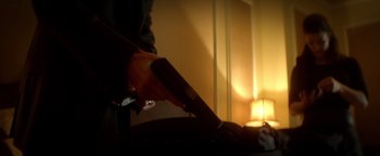 A person holding a gun in a room