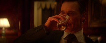 Movie still from “Haywire” (2011), directed by Steven Soderbergh – A man in a suit and tie drinking a glass of wine; Close Up shot, Over the shoulder angle