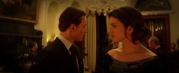 Movie still from “Haywire” (2011), directed by Steven Soderbergh – A man and a woman standing next to each other; Medium shot, Low angle