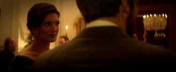 Movie still from “Haywire” (2011), directed by Steven Soderbergh – A woman standing next to a man in front of a candle; Close Up shot, Over the shoulder angle