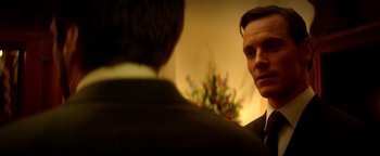 Movie still from “Haywire” (2011), directed by Steven Soderbergh – A man in a suit and tie looking at another man in a suit and tie; Close Up shot, Over the shoulder angle