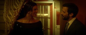 Movie still from “Haywire” (2011), directed by Steven Soderbergh – A woman smiling in front of an open door; Close Up shot, Over the shoulder angle