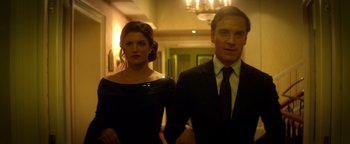 Movie still from “Haywire” (2011), directed by Steven Soderbergh – A man and a woman standing next to each other in a hallway; Medium shot, Low angle