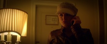 Movie still from “Haywire” (2011), directed by Steven Soderbergh – A woman wearing a hat is talking on a cell phone; Close Up shot, Low angle