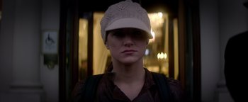 Movie still from “Haywire” (2011), directed by Steven Soderbergh – A woman wearing a white hat and a brown shirt; Close Up shot, Low angle