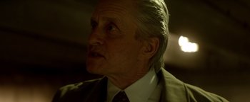 Movie still from “Haywire” (2011), directed by Steven Soderbergh – An older man wearing a suit and a tie; Close Up shot, Over the shoulder angle