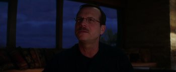 Movie still from “Haywire” (2011), directed by Steven Soderbergh – A person wearing glasses and a black shirt; Close Up shot, Low angle