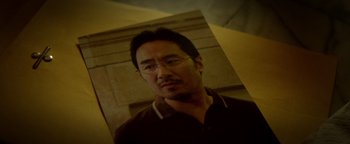 Movie still from “Haywire” (2011), directed by Steven Soderbergh – A picture of a man with glasses and a brown shirt; Extreme Close Up shot, High angle