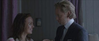 Movie still from “Headhunters” (2011), directed by Morten Tyldum – A man and a woman are looking at one another; Close Up shot, Over the shoulder angle
