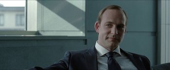 Movie still from “Headhunters” (2011), directed by Morten Tyldum – A man in a suit and a tie; Close Up shot, Over the shoulder angle
