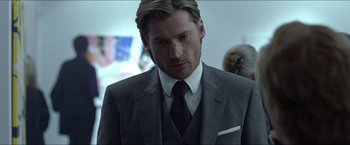 Movie still from “Headhunters” (2011), directed by Morten Tyldum – A person wearing a suit and tie; Close Up shot, Over the shoulder angle