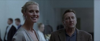 Movie still from “Headhunters” (2011), directed by Morten Tyldum – A woman and a man standing next to each other in a room; Close Up shot, Over the shoulder angle