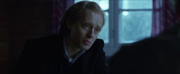 Movie still from “Headhunters” (2011), directed by Morten Tyldum – A person sitting in front of a computer screen; Close Up shot, Over the shoulder angle