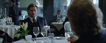 Movie still from “Headhunters” (2011), directed by Morten Tyldum – A man and woman sitting at a dinner table; Medium shot, Over the shoulder angle