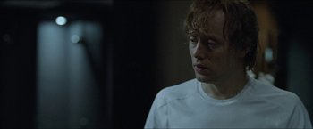 Movie still from “Headhunters” (2011), directed by Morten Tyldum – A man in a white shirt is looking at the camera; Close Up shot, Over the shoulder angle