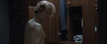Movie still from “Headhunters” (2011), directed by Morten Tyldum – A young man with curly blond hair in a bathroom; Close Up shot, Over the shoulder angle