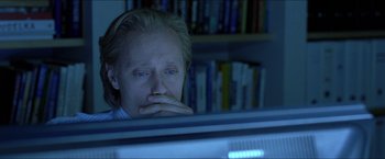 Movie still from “Headhunters” (2011), directed by Morten Tyldum – A man sitting in front of a computer monitor; Close Up shot, High angle