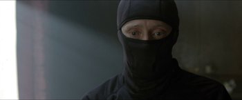 Movie still from “Headhunters” (2011), directed by Morten Tyldum – A man wearing a black balaclava is looking at the camera; Close Up shot, Over the shoulder angle