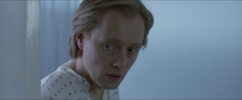 Movie still from “Headhunters” (2011), directed by Morten Tyldum – A person with long blonde hair; Close Up shot, Over the shoulder angle